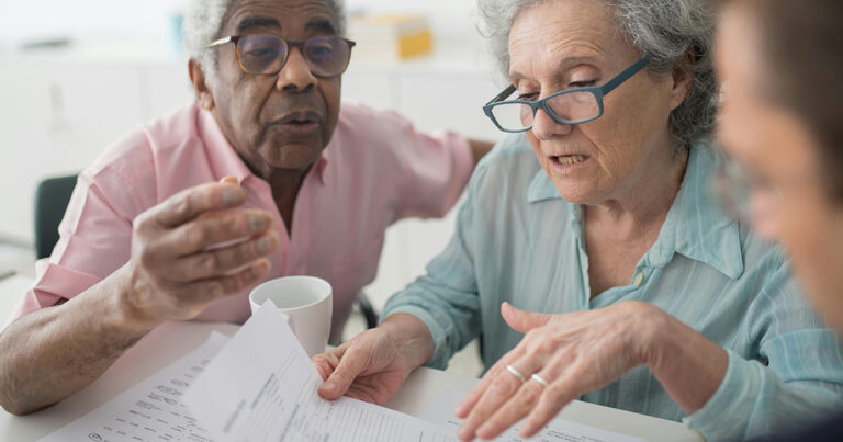 Interracial Seniors looking at legal documents