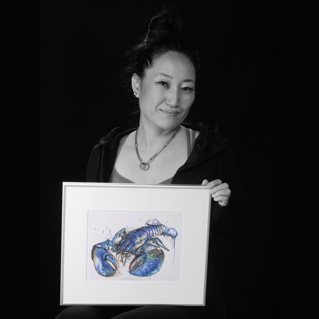 Ji Hyang Ryu holding artwork