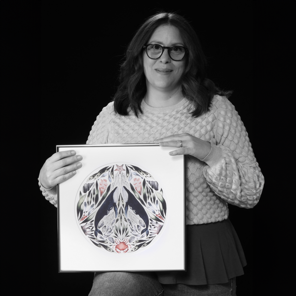 Monica Chamberlain holding her artwork