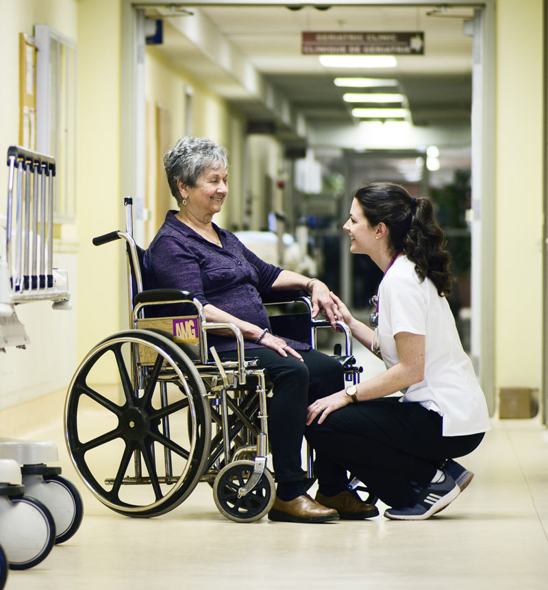 Lady in wheelchair with Caregiver smiling