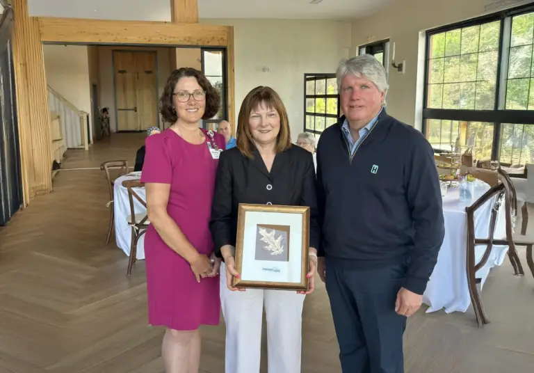 Three Adults hold a Gift in your Will picture frame